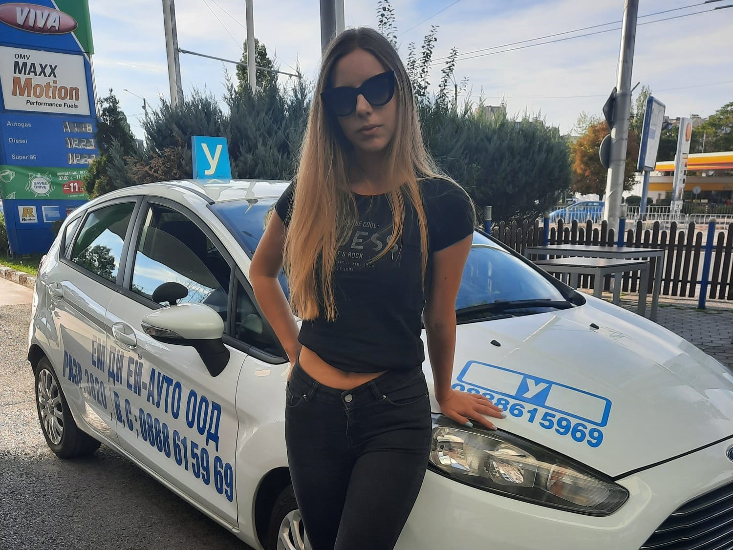 girl posing in front of car